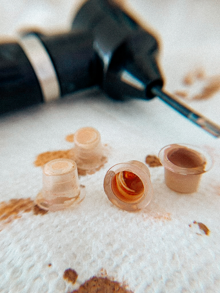 Custom-blended skin-tone pigments and precision tattoo tool